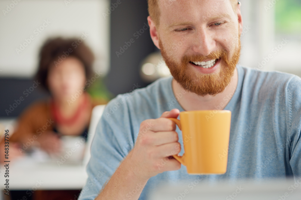 Businessman working while sitting at the desk and drinking coffee. Close up Businessman working while sitting at the desk and drinking coffee. Close up