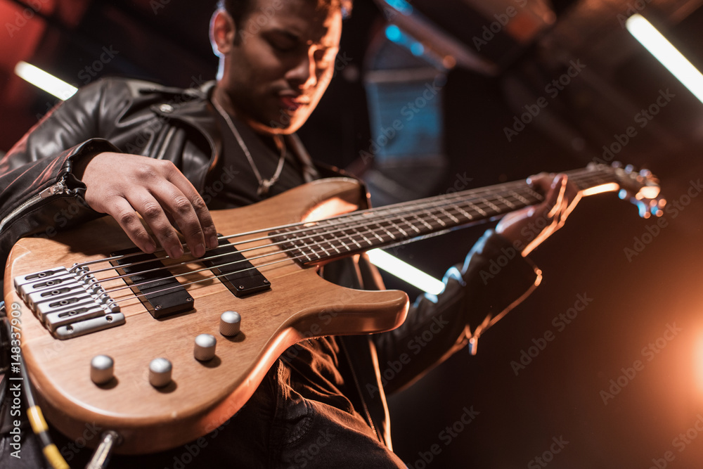 Fototapeta premium Electric guitar player playing hard rock music with bass guitar on stage