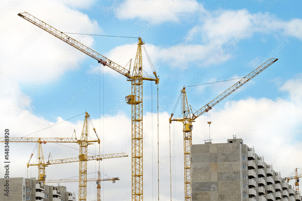 Construction crane and building on blue sky background Construction crane and building on blue sky background