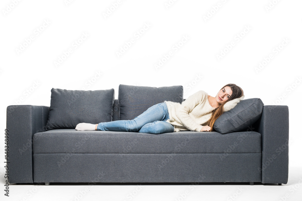 Beautiful woman lying on a white sofa, isolated on white background Beautiful woman lying on a white sofa, isolated on white background