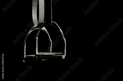 Canvastavla horse tirrup on black background, copy space