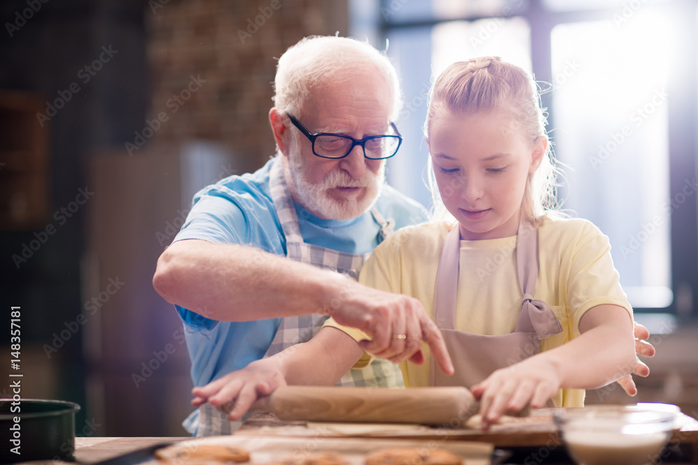 grandfather and granddaughter making dough grandfather and granddaughter making dough