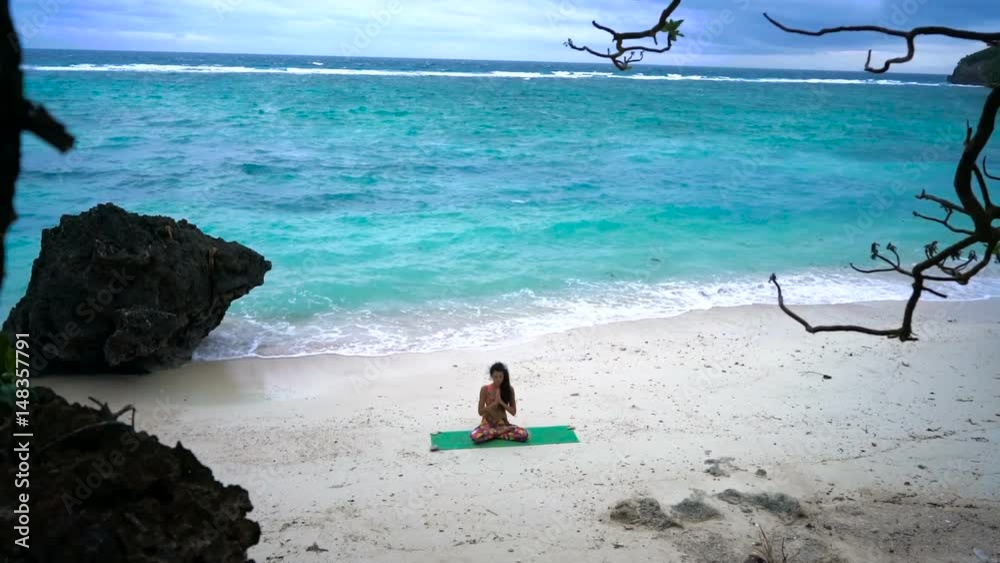 Girl on the beach practicing yoga Girl on the beach practicing yoga