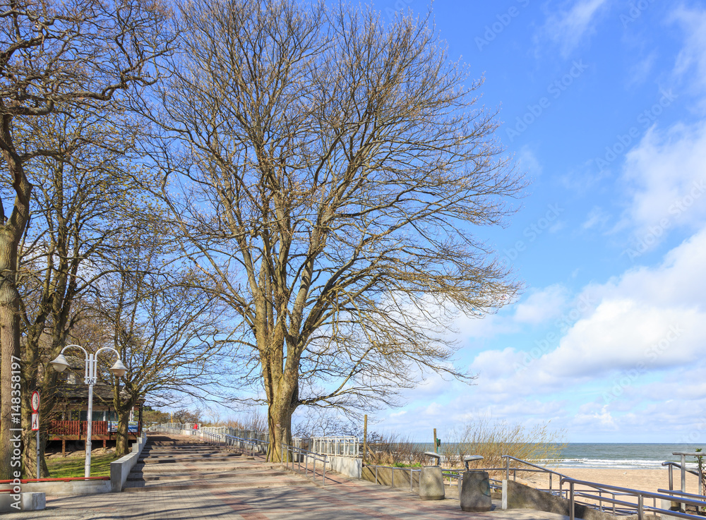 Ustka na polskim pomorzu na północ od Słupska. Nadmorska promenada oświetlona południowym słońcem 