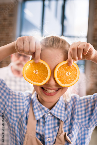 girl holding orange slices
