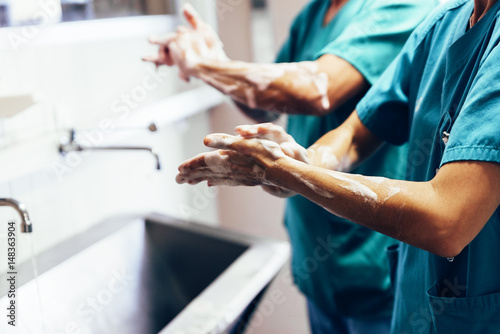 Couple of Surgeons Washing Hands Before Operating. photo