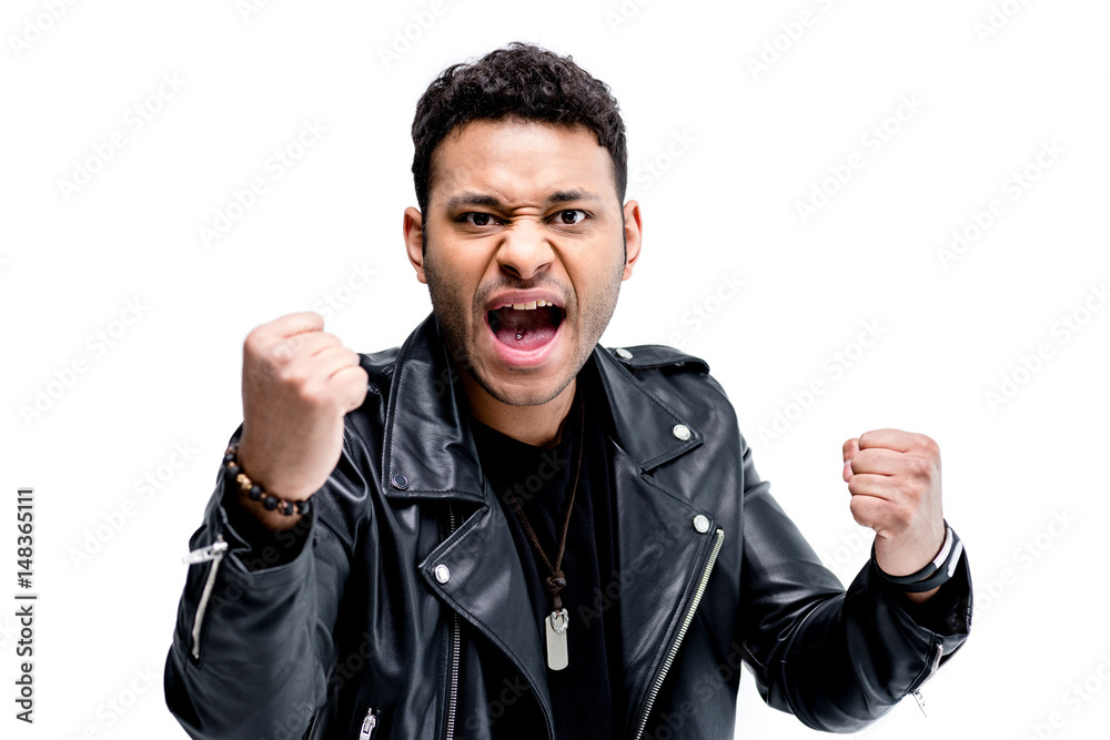 portrait of emotional african american rocker in black leather jacket posing isolated on white