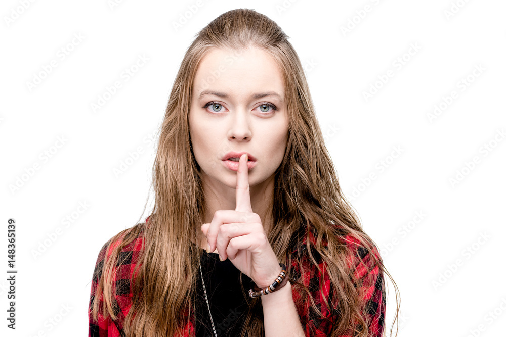 portrait of young attractive woman with silence gesture looking at camera isolated on white portrait of young attractive woman with silence gesture looking at camera isolated on white