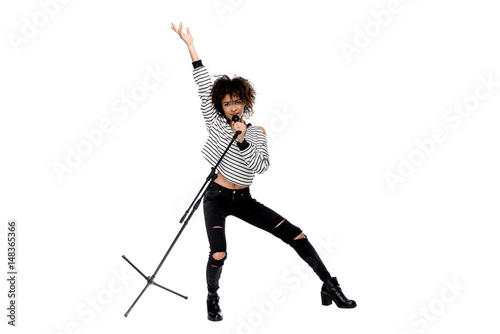 Photography Full length view of beautiful young woman with microphone singing and gesturing