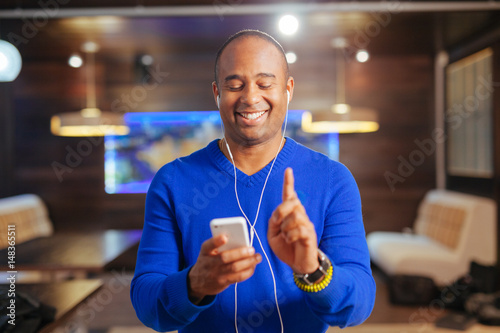 young attractive man with headphones and mobile phone listening to music