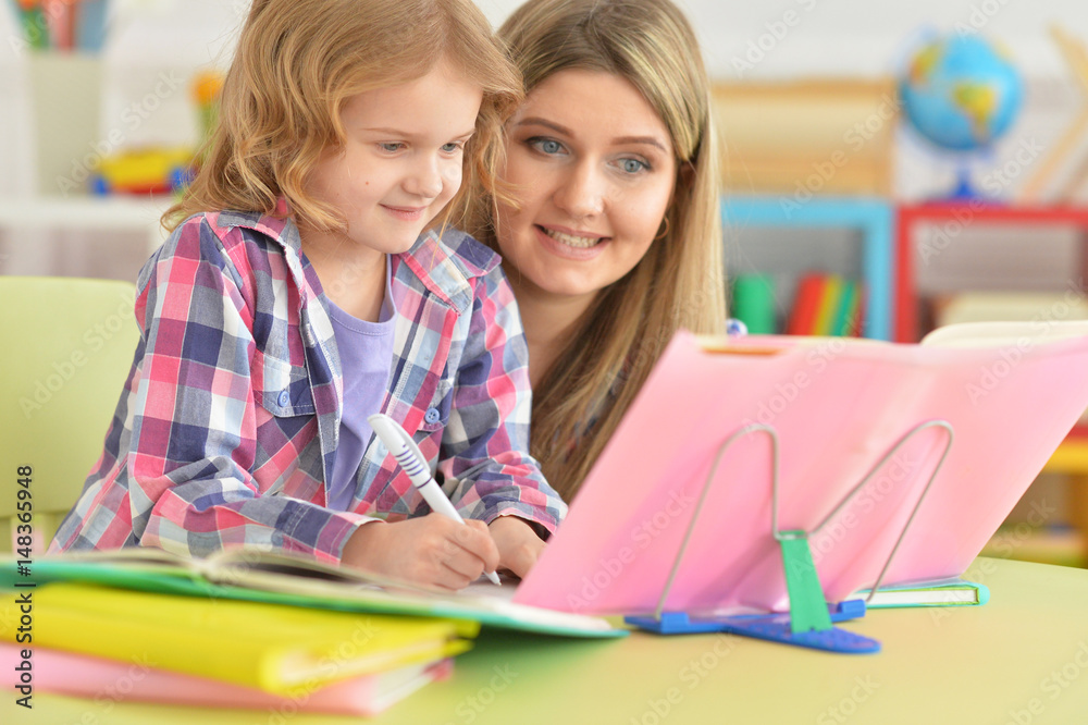 Mother and daughter doing their homework Mother and daughter doing their homework