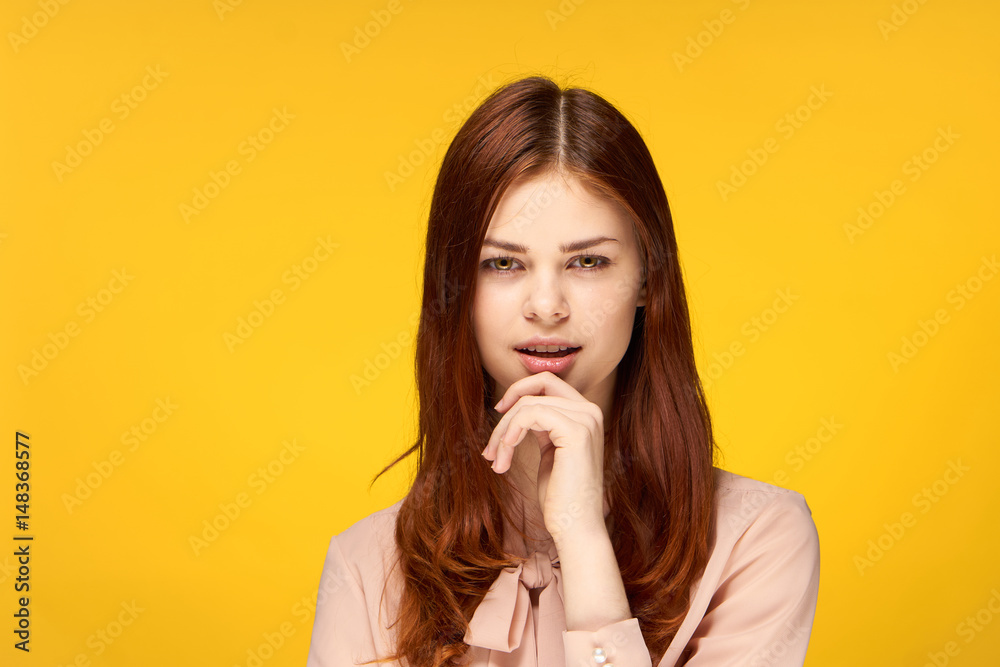 beautiful, red-haired, confident woman on a yellow background beautiful, red-haired, confident woman on a yellow background