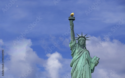 Statue of Liberty over blue sky © gdvcom