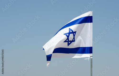 Vászonkép The israeli flag in blue sky at Israeli Independence day