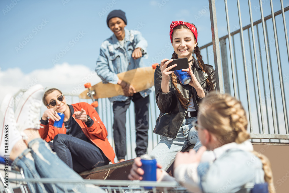 Fototapeta premium Teenagers group having fun together on ramp at skateboard park