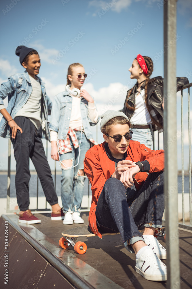 Fototapeta premium teenagers spending time at skateboard park, teenagers having fun concept