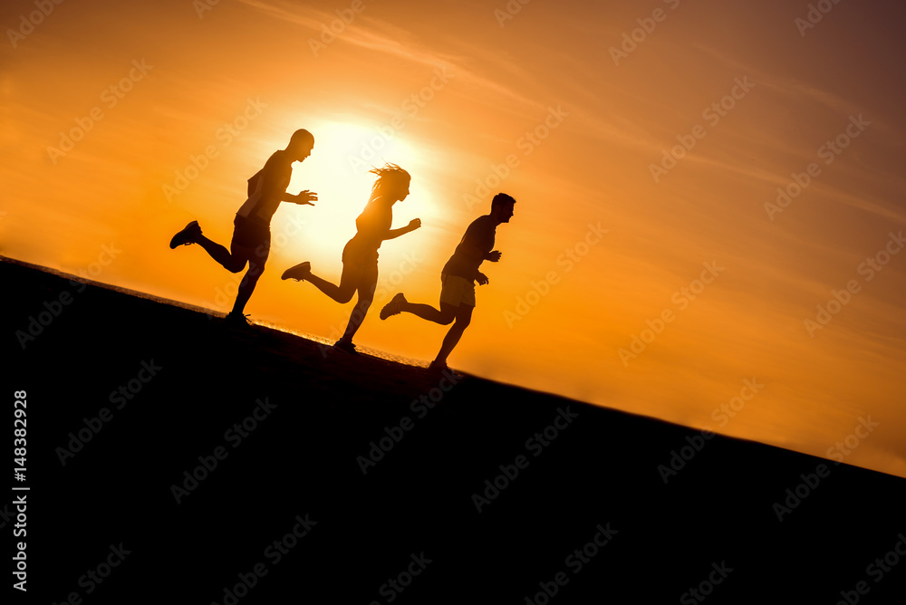 People running at beach. Group of people training at morning.