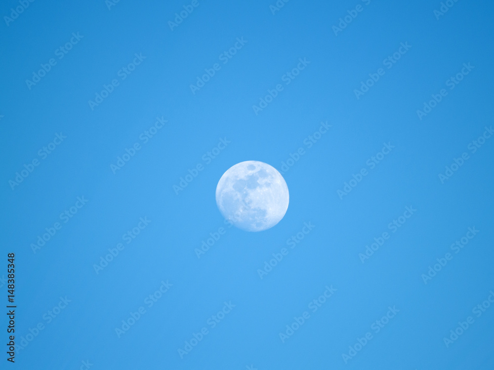 Moon in the fourth quarter on a blue sky