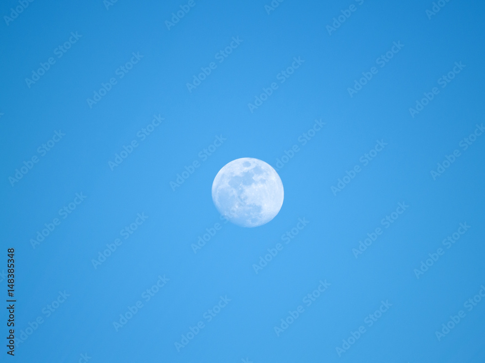 Obraz premium Moon in the fourth quarter on a blue sky
