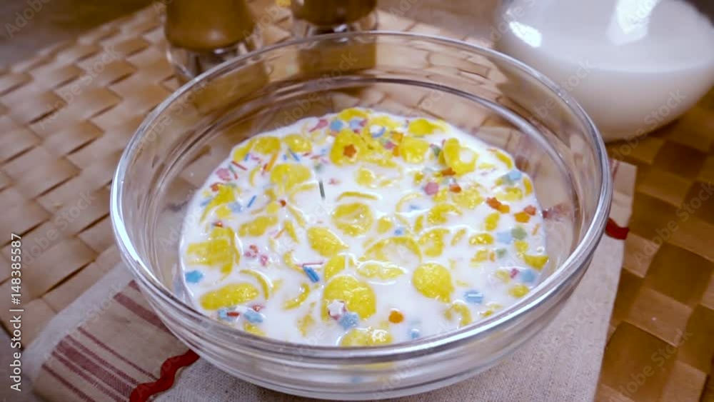 Crispy yellow corn flakes into the bowl for the morning a delicious Breakfast with milk. Slow motion with rotation Crispy yellow corn flakes into the bowl for the morning a delicious Breakfast with milk. Slow motion with rotation