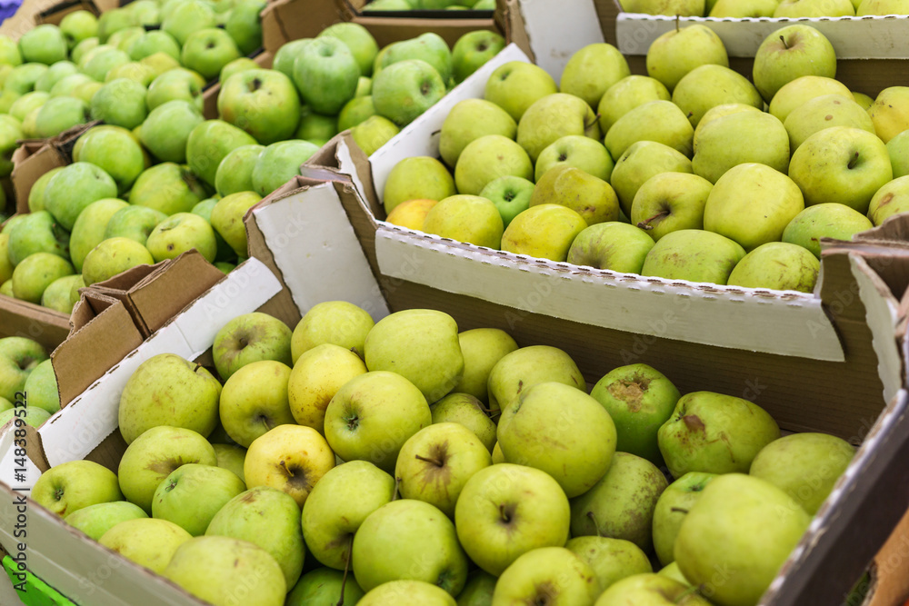 Boxes of green apples in the market
