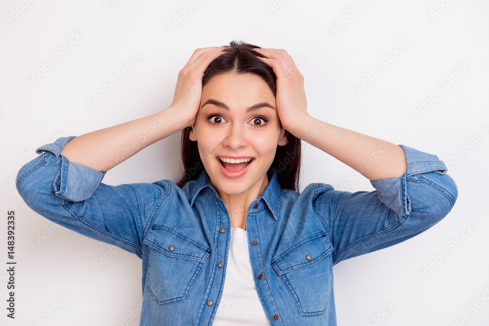 Portrait of very excited happy girl holding her head in amazement on white background Portrait of very excited happy girl holding her head in amazement on white background