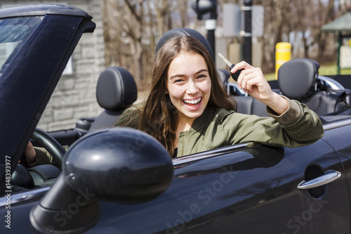 young brunette woman in new car