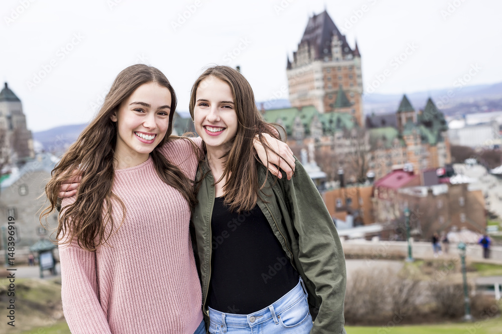 Fototapeta premium Quebec City scape with Chateau Frontenac and young friend teens enjoying the view.