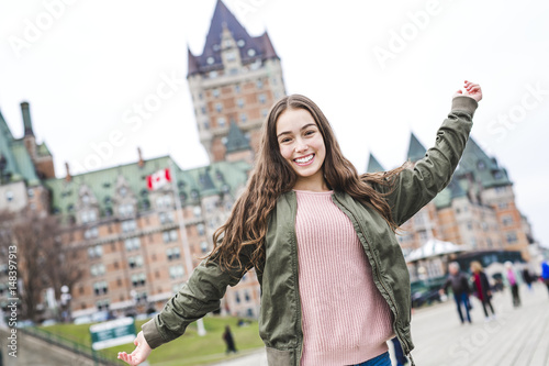 Quebec City scape with Chateau Frontenac and young teen enjoying the view. photo