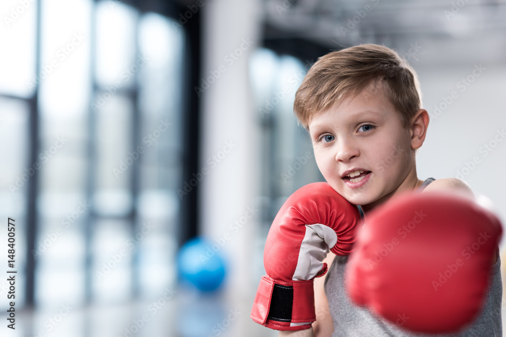 Portrait of young boy boxer in red boxing gloves Portrait of young boy boxer in red boxing gloves