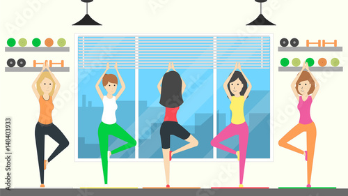 Yoga class training. Women do yoga in gym.