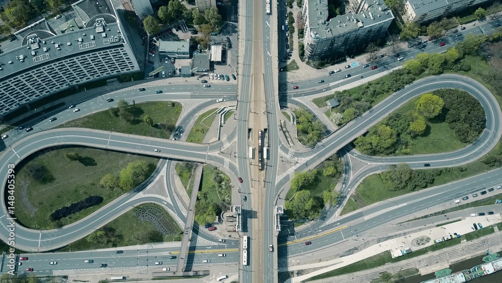 Aerial shot of big urban road junction on a sunny day, top down view