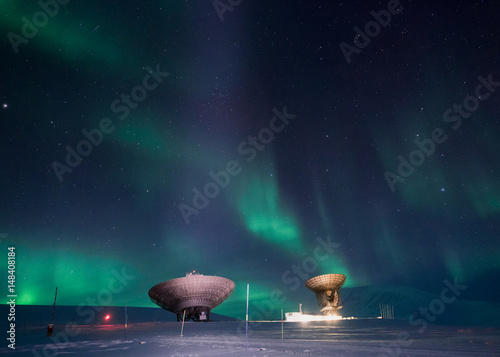 The polar Northern aurora borealis lights in Norway Svalbard in the mountains photo