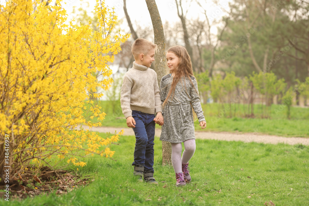 Fototapeta premium Pretty little girl and cute boy walking in spring park