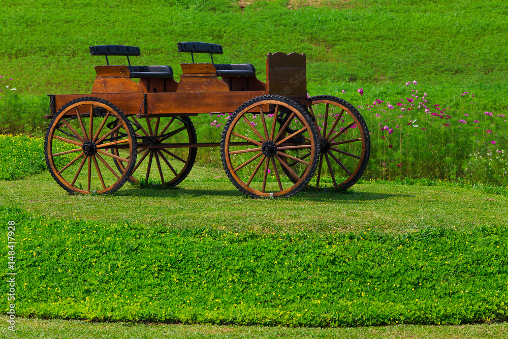 Wooden wagon in flower garden for decoration.