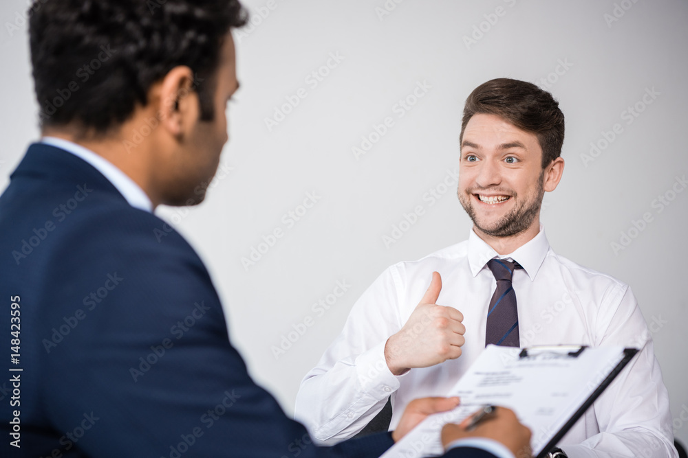 side view of professional businessmen having business meeting at company side view of professional businessmen having business meeting at company