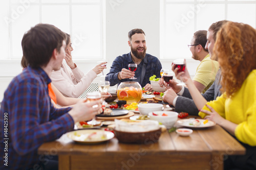 Group of happy people at festive table dinner party © Prostock-studio