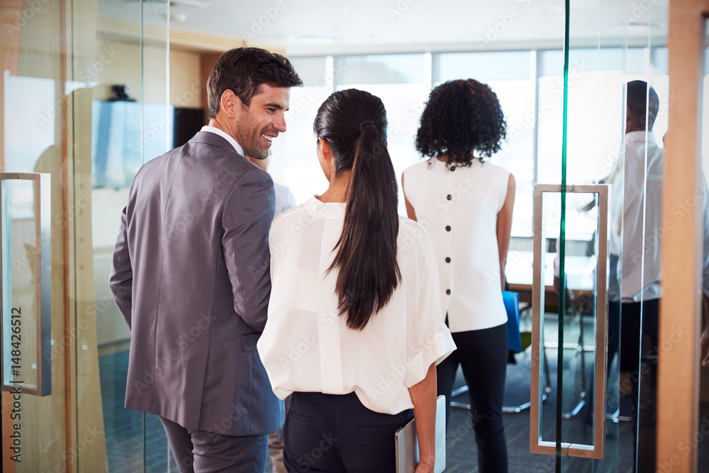 Rear View Of Businesspeople Entering Boardroom For Meeting Rear View Of Businesspeople Entering Boardroom For Meeting