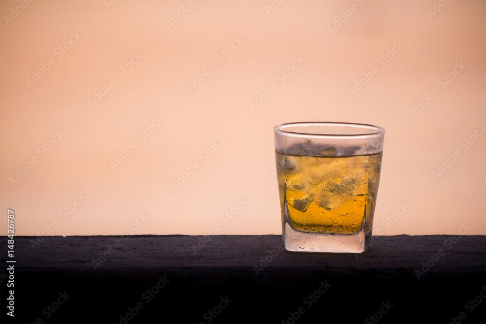 a glass of beer on concrete wall near sea background in evening a glass of beer on concrete wall near sea background in evening