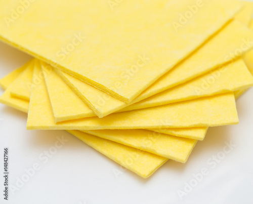 Vibrant yellow cloth kitchen napkins isolated on white.