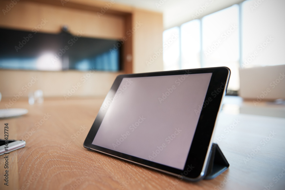 Digital Tablet On Empty Boardroom Table In Office