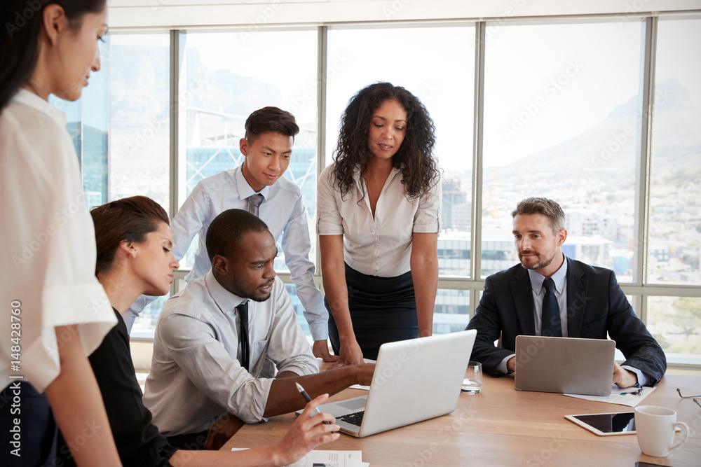 Group Of Businesspeople Meeting Around Table In Office