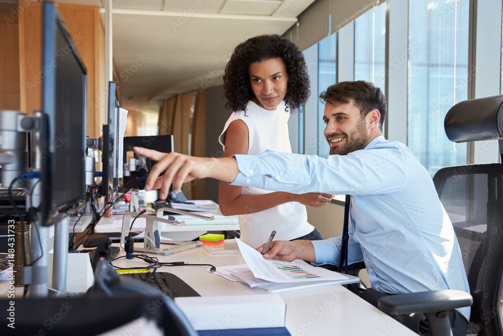 Fototapeta premium Businesspeople Working At Office Desk On Computer Together