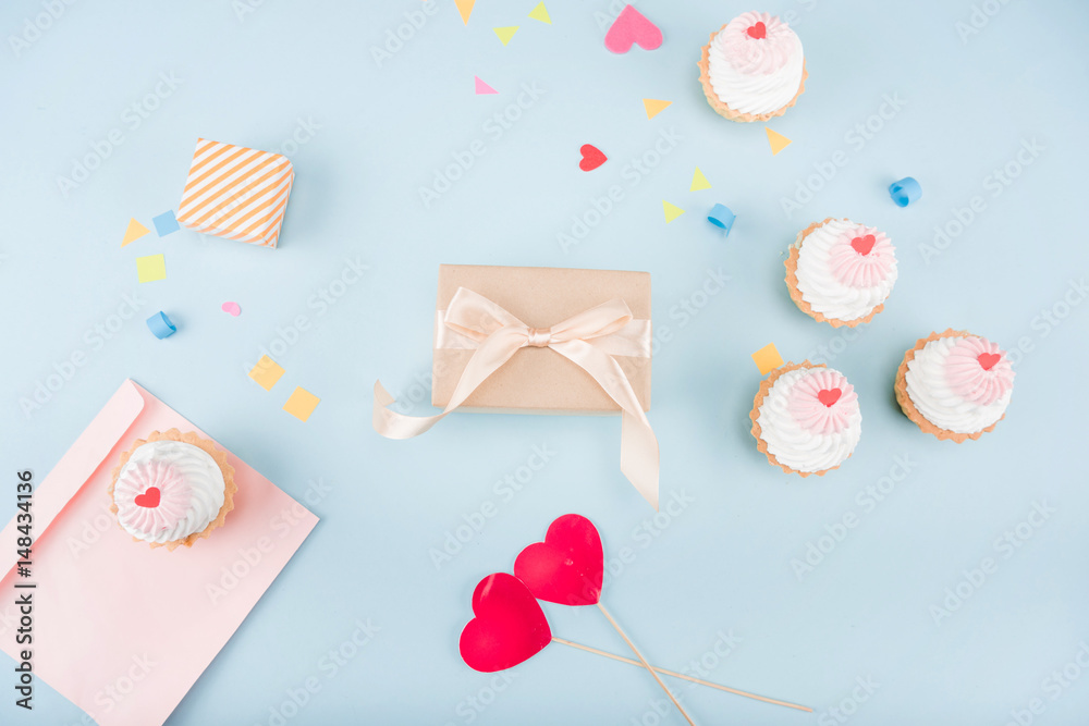 top view of cakes and gift boxes with envelope mock-up, birthday party