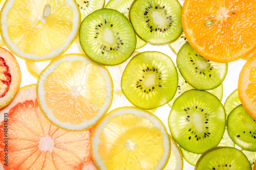 Beautiful fresh sliced mixed citrus fruits as background