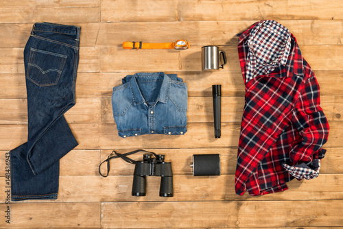 Traveler set on wooden background, flat lay