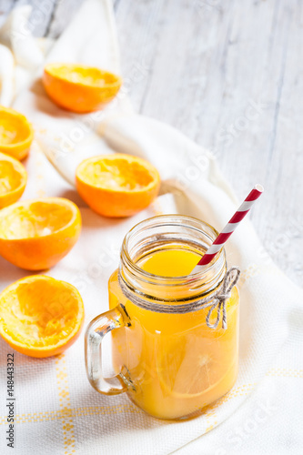 Orange juice with remains of shells in glass jar.