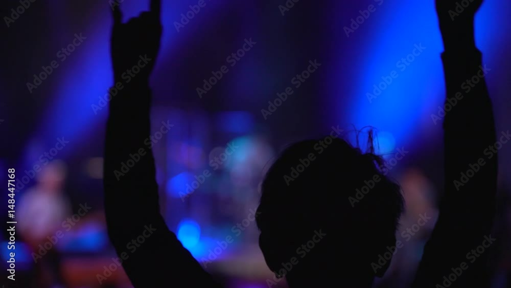 Silhouette of a dancing woman on a rock concert Silhouette of a dancing woman on a rock concert