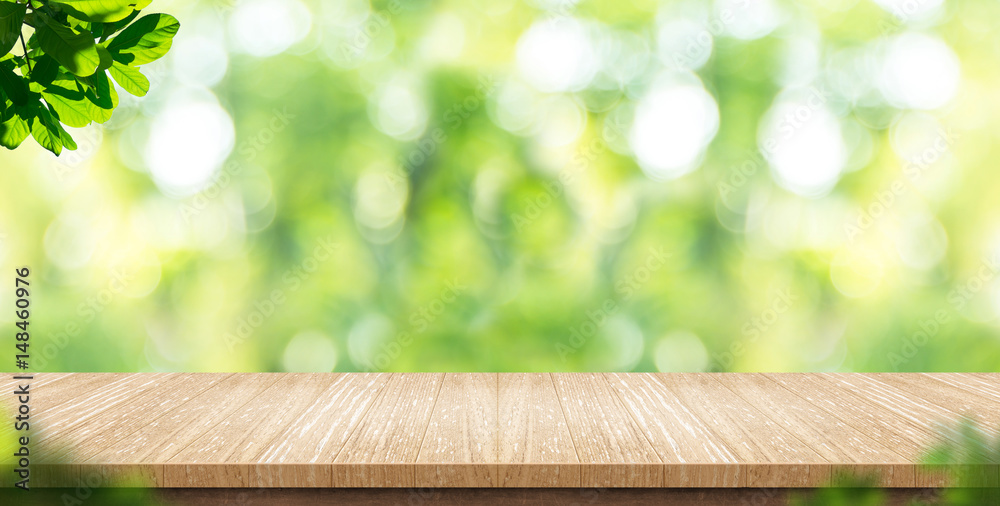 Empty wood plank table top with blur park green nature background bokeh light,Mock up for display or montage of product,Banner or header for advertise on social media,Spring and Summer concept - obrazy, fototapety, plakaty 