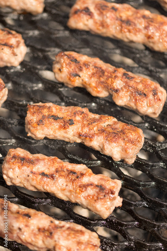 Grilling minced meat kebabs on the barbecue with selective focus